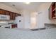 Kitchen with granite counters, wood cabinets, and modern white appliances at 404 Central Mariners Dr, Edgewater, FL 32141