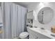 Bathroom with a new vanity, a round mirror, and a shower/tub with curtain at 412 Banana Cay Dr # A, South Daytona, FL 32119