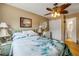 Relaxing bedroom with natural lighting, a ceiling fan, and access to an ensuite bathroom at 412 Banana Cay Dr # A, South Daytona, FL 32119