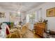 Bright dining area showcasing a round glass table, wicker chairs, and decorative seashell artwork at 412 Banana Cay Dr # A, South Daytona, FL 32119