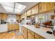 Well-lit kitchen with light wood cabinets, white countertops, and an open view to the dining area at 412 Banana Cay Dr # A, South Daytona, FL 32119