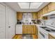 Charming kitchen with light wood cabinets and white appliances, creating a cozy cooking space at 412 Banana Cay Dr # A, South Daytona, FL 32119