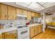 Functional kitchen with light wood cabinetry, ample countertop space, and white appliances at 412 Banana Cay Dr # A, South Daytona, FL 32119