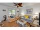 Bright living room featuring hardwood floors, a comfortable sofa, and natural lighting at 412 Banana Cay Dr # A, South Daytona, FL 32119