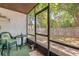 Relaxing screened-in porch with a view of the yard and a cozy seating area at 412 Banana Cay Dr # A, South Daytona, FL 32119