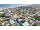 Aerial neighborhood view of beachside community with colorful buildings, mature trees, and convenient access to the ocean at 415 Jessamine Ave, New Smyrna Beach, FL 32169