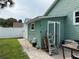 Backyard view of the home's exterior, featuring a tool shed and a small patio area at 415 Jessamine Ave, New Smyrna Beach, FL 32169