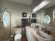 Well-lit bathroom featuring a sink with cabinet storage, a shower, and tropical decor at 415 Jessamine Ave, New Smyrna Beach, FL 32169