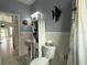 Bright bathroom featuring modern fixtures, storage, a shower with curtain, and a decorative fish at 415 Jessamine Ave, New Smyrna Beach, FL 32169