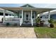 Charming home featuring a cozy covered front porch, manicured lawn and brick paver walkway at 415 Jessamine Ave, New Smyrna Beach, FL 32169