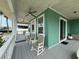 Spacious front porch with rocking chairs and a ceiling fan for outdoor enjoyment at 415 Jessamine Ave, New Smyrna Beach, FL 32169