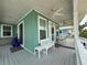 Charming front porch with ceiling fans, bench seating, and a view of neighboring houses at 415 Jessamine Ave, New Smyrna Beach, FL 32169
