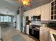 Kitchen features stainless steel appliances and is open to the dining area at 415 Jessamine Ave, New Smyrna Beach, FL 32169
