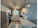 Kitchen with white cabinets, stainless steel appliances and marble counter space at 415 Jessamine Ave, New Smyrna Beach, FL 32169