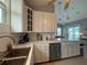Charming kitchen features marble countertops, white cabinets and stainless steel dishwasher at 415 Jessamine Ave, New Smyrna Beach, FL 32169