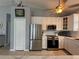 Kitchen showcases stainless steel appliances, white cabinetry and modern countertops at 415 Jessamine Ave, New Smyrna Beach, FL 32169