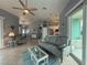 Inviting living room with tile flooring, ceiling fan and slider leading to a porch at 415 Jessamine Ave, New Smyrna Beach, FL 32169