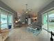 Bright living room with tile floors and open floor plan seamlessly connecting to the kitchen at 415 Jessamine Ave, New Smyrna Beach, FL 32169