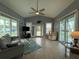 Inviting living room with tile flooring, vaulted ceiling, and sliding glass doors to the outdoor space at 415 Jessamine Ave, New Smyrna Beach, FL 32169