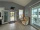 Bright living room featuring a recliner, tile flooring, front door and access to the porch at 415 Jessamine Ave, New Smyrna Beach, FL 32169