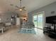 Bright living room with tile floors and open floor plan seamlessly connecting to the kitchen at 415 Jessamine Ave, New Smyrna Beach, FL 32169