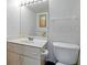 Neat bathroom featuring a well-lit mirror and clean white fixtures for a fresh, minimalist design at 4175 S Atlantic Ave # 4050, New Smyrna Beach, FL 32169