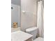 Well-lit bathroom with a white shower curtain and fixtures for a simple, serene atmosphere at 4175 S Atlantic Ave # 4050, New Smyrna Beach, FL 32169