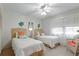 Charming bedroom features two twin beds, ceiling fan, and neutral decor at 4175 S Atlantic Ave # 4050, New Smyrna Beach, FL 32169