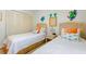 Comfortable bedroom with twin beds, beachy decor, and plenty of natural light at 4175 S Atlantic Ave # 4050, New Smyrna Beach, FL 32169