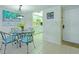 Charming dining area featuring kitchen access and a decorative light fixture at 4175 S Atlantic Ave # 4050, New Smyrna Beach, FL 32169