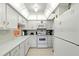 Well-lit kitchen features white appliances and ample counter space for easy meal preparation at 4175 S Atlantic Ave # 4050, New Smyrna Beach, FL 32169