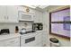 Cozy kitchen offering modern white appliances and window bringing in natural light at 4175 S Atlantic Ave # 4050, New Smyrna Beach, FL 32169