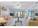 Well-lit living room with cozy sofas and balcony access at 4175 S Atlantic Ave # 4050, New Smyrna Beach, FL 32169