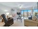Comfortable living room with natural light and relaxing recliner at 4175 S Atlantic Ave # 4050, New Smyrna Beach, FL 32169