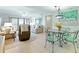 Open-concept living and dining area with sliding glass doors and furnishings at 4175 S Atlantic Ave # 4050, New Smyrna Beach, FL 32169