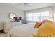 Inviting bedroom with a dresser and large windows providing plenty of natural light at 4175 S Atlantic Ave # 4050, New Smyrna Beach, FL 32169