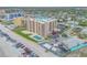 Aerial view of the beachfront condo, pool, manicured lawns and convenient parking at 421 S Atlantic Ave # 507, New Smyrna Beach, FL 32169