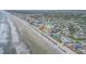 Stunning aerial view showcasing the oceanfront property with beautiful beach and surroundings at 421 S Atlantic Ave # 507, New Smyrna Beach, FL 32169