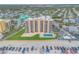 Aerial view of the property featuring a pool, manicured lawns, and convenient beach access at 421 S Atlantic Ave # 507, New Smyrna Beach, FL 32169