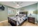 Cozy bedroom with dark wood furniture, ceiling fan, and calming green walls, offering a comfortable retreat at 421 S Atlantic Ave # 507, New Smyrna Beach, FL 32169