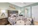 Well-lit bedroom with view to bathroom, decorated with calming wall art, inviting relaxation and comfort at 421 S Atlantic Ave # 507, New Smyrna Beach, FL 32169