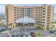 Exterior shot of a condo building with palm trees and a large parking lot at 421 S Atlantic Ave # 507, New Smyrna Beach, FL 32169