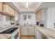 Updated kitchen with marble countertops, white appliances, and light wood cabinets at 421 S Atlantic Ave # 507, New Smyrna Beach, FL 32169