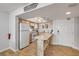 Well-lit kitchen with light wood cabinets, marble countertops, and stainless steel appliances at 421 S Atlantic Ave # 507, New Smyrna Beach, FL 32169