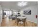 Open concept living room with modern decor, wood floors, and sliding glass doors with ocean views at 421 S Atlantic Ave # 507, New Smyrna Beach, FL 32169