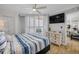 Inviting bedroom with a view and shuttered windows, complemented by a ceiling fan at 421 S Atlantic Ave # 507, New Smyrna Beach, FL 32169