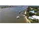 An aerial view showcasing a riverfront home with private dock and swimming pool at 426 Bouchelle Dr # 401, New Smyrna Beach, FL 32169