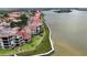 Aerial view of waterfront condos, landscaping, and dockage along the water, offering stunning coastal living at 426 Bouchelle Dr # 401, New Smyrna Beach, FL 32169