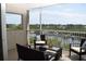 Relaxing screened balcony with comfortable seating and picturesque views of the marina at 426 Bouchelle Dr # 401, New Smyrna Beach, FL 32169