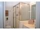 Modern bathroom with a glass-enclosed shower, vanity, and toilet, designed for functionality and style at 426 Bouchelle Dr # 401, New Smyrna Beach, FL 32169